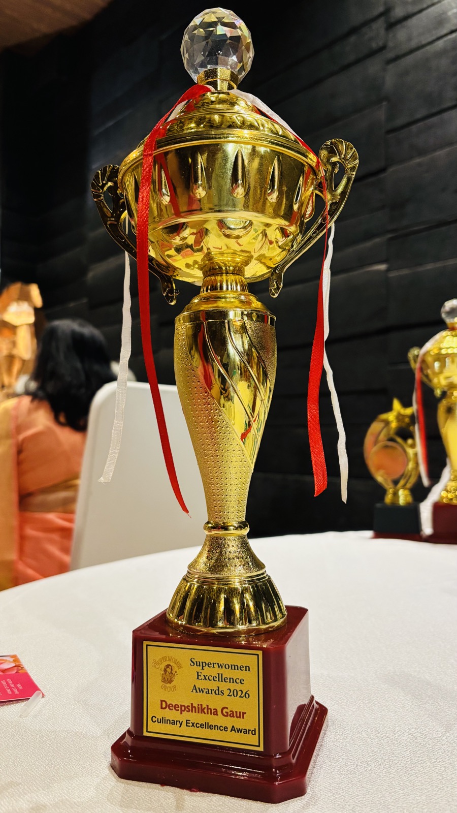 Actual trophy naming Deepshikha Gaur, Culinary Excellence Award, Superwomen Excellence Awards 2026.